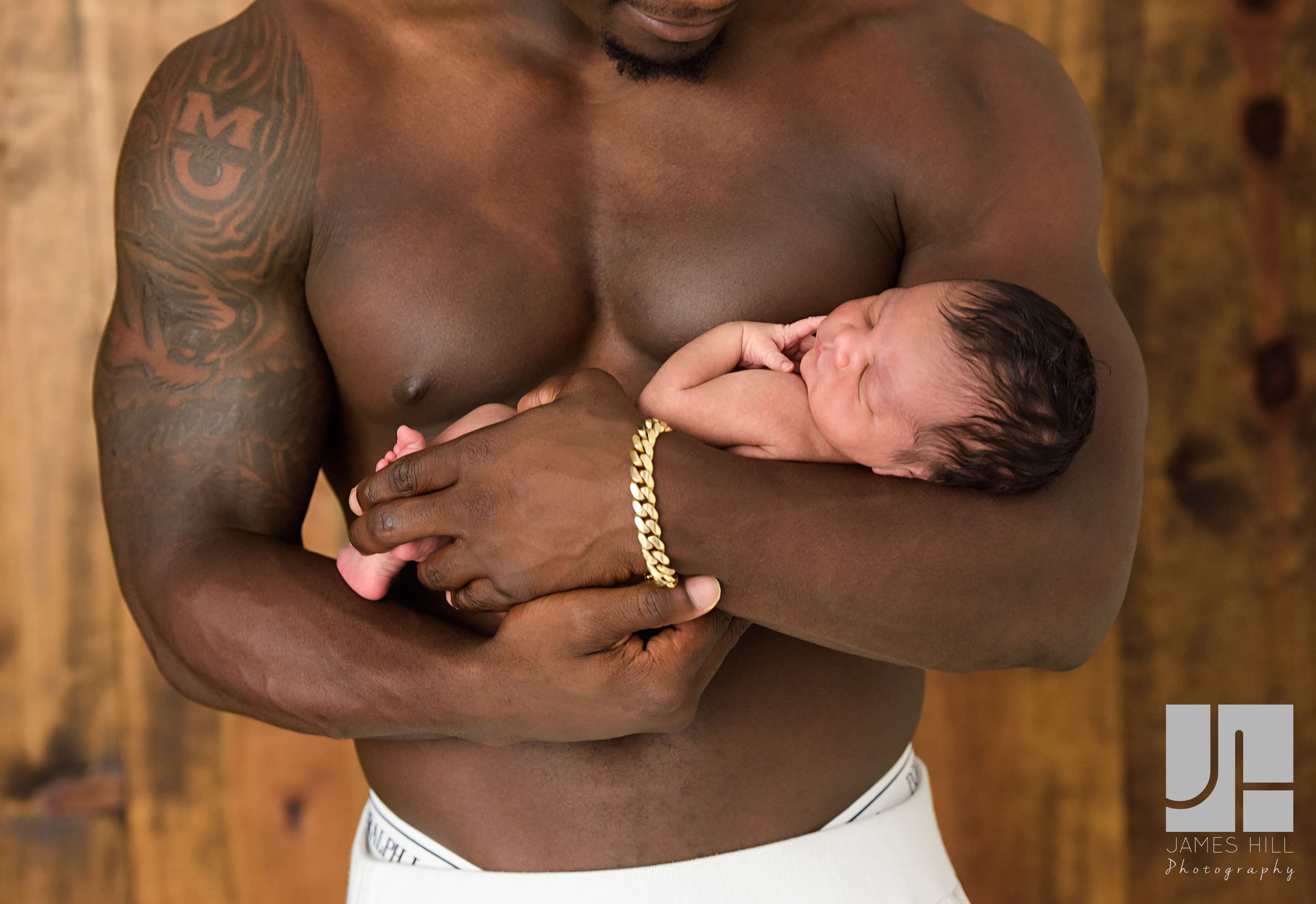 Sean Weatherspoon holding his newborn baby