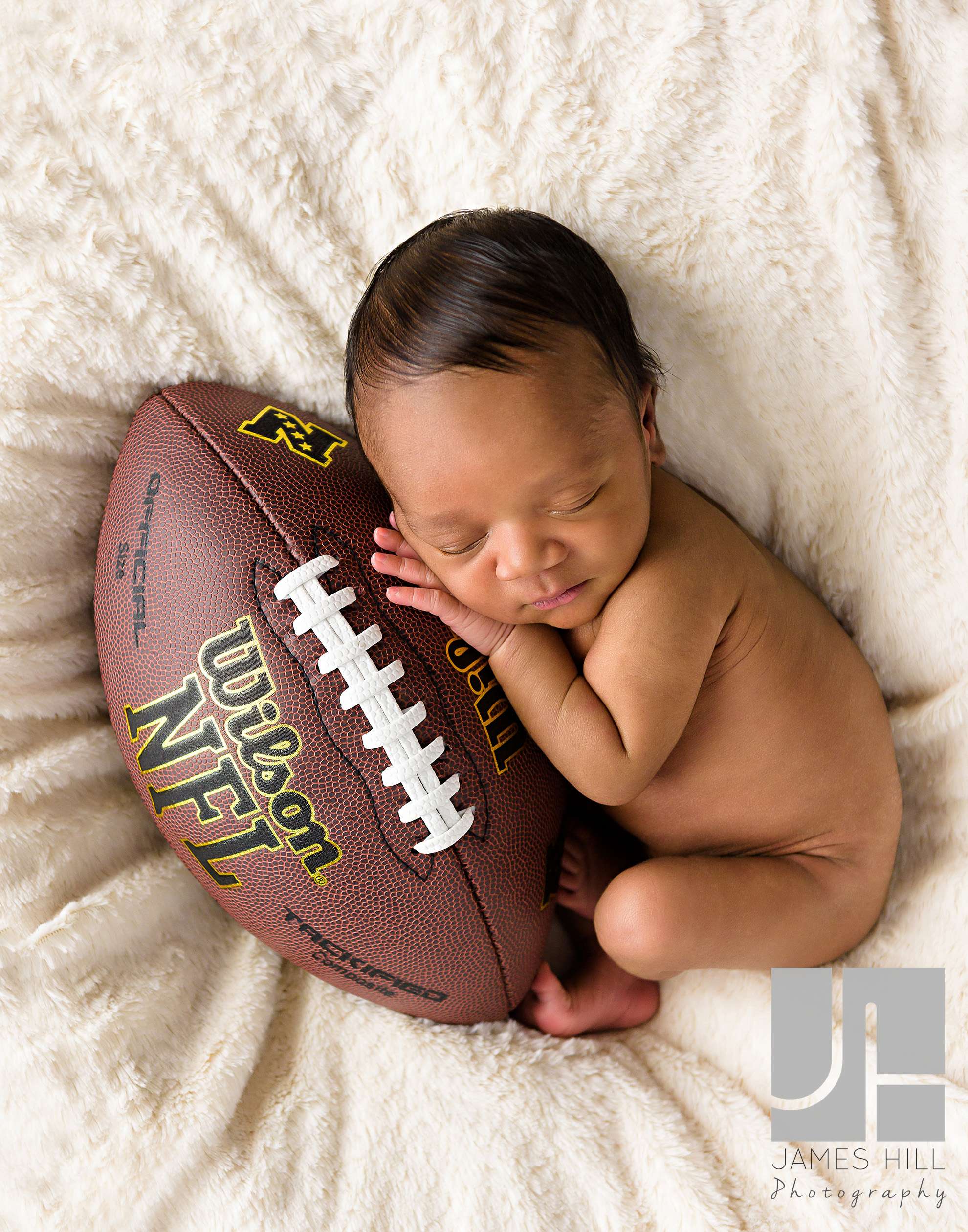 baby holding football