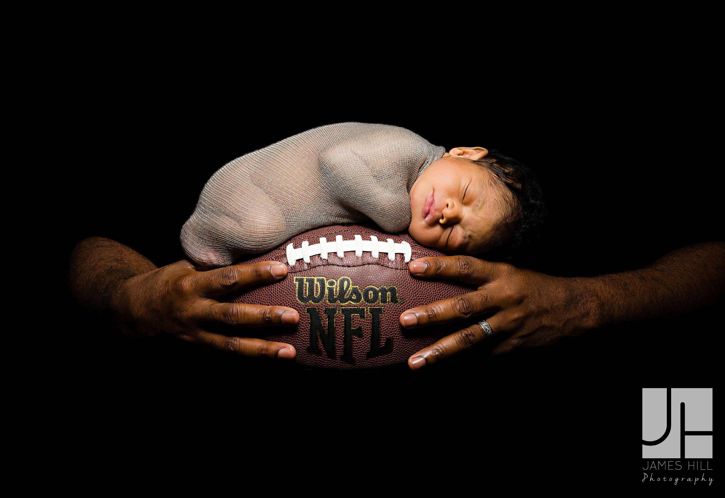 Daddy LOVES sports! RJ and Sullivan were both photographed with the same football. 