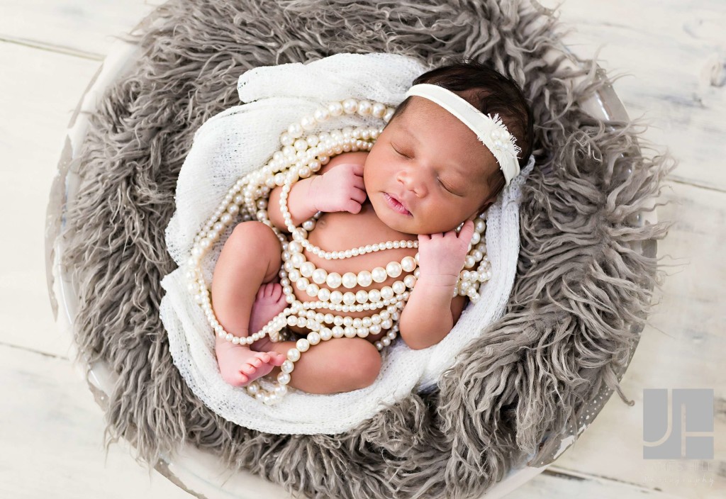 Newborn wrapped in pearls
