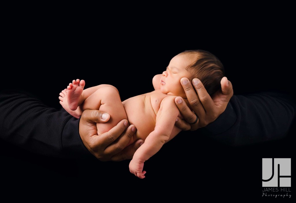 Newborn in Dad's Hands